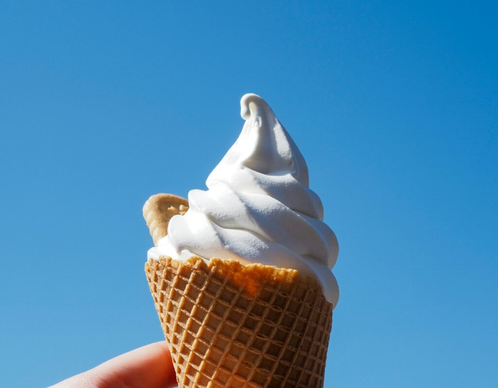 Soft serve ice cream in a waffle cone.